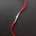 Radiant Pearl Rakhi: Symbolizing Purity and Love