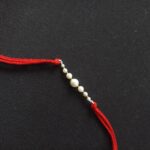 Radiant Pearl Rakhi: Symbolizing Purity and Love