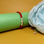 Simple & Elegant Pure Beads Rakhi with Red Thread