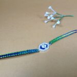 Pure Silver Ganesh Rakhi with Sacred Symbol & Traditional Thread