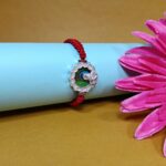 Pure Silver Krishna Rakhi with Green Enamel & Red Braided Thread