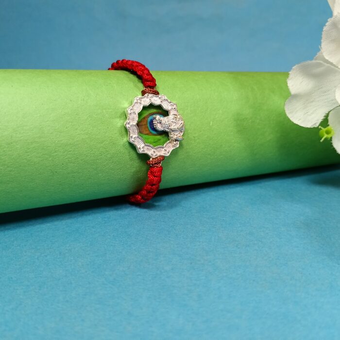 Pure Silver Krishna Rakhi with Green Enamel & Red Braided Thread