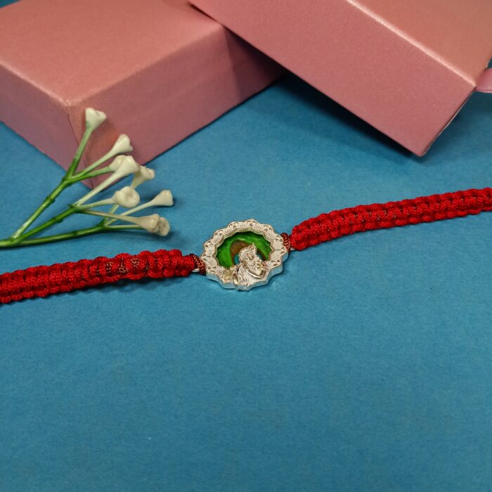 Pure Silver Krishna Rakhi with Green Enamel & Red Braided Thread