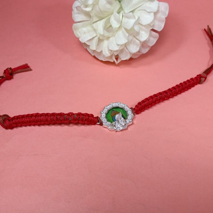 Pure Silver Krishna Rakhi with Green Enamel & Red Braided Thread