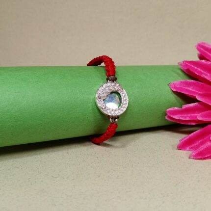 Pure Silver Peacock Feather Rakhi with Red Braided Thread