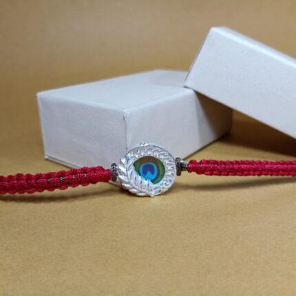 Pure Silver Peacock Feather Rakhi with Red Braided Thread