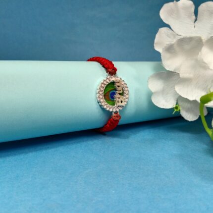 Pure Silver "Bhai" Rakhi with Peacock Feather Design & Red Braided Thread