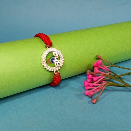Pure Silver "Bhai" Rakhi with Peacock Feather Design & Red Braided Thread