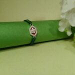 Silver Ganesha Rakhi with Green & Blue Thread