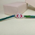 Silver Ganesha Rakhi with Green & Blue Thread