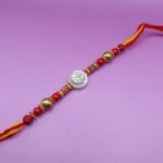 Pure Silver Ganesh Rakhi with Beads Red & Yellow Thread