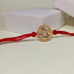 Divine Om Golden Rakhi: Sterling Silver Elegance