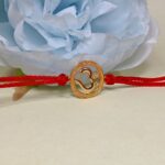 Divine Om Golden Rakhi: Sterling Silver Elegance
