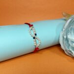 Elegant 925 Silver Rakhi with Pearls & Blue Stone Accents