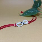 Elegant 925 Silver Rakhi with Pearls & Blue Stone Accents