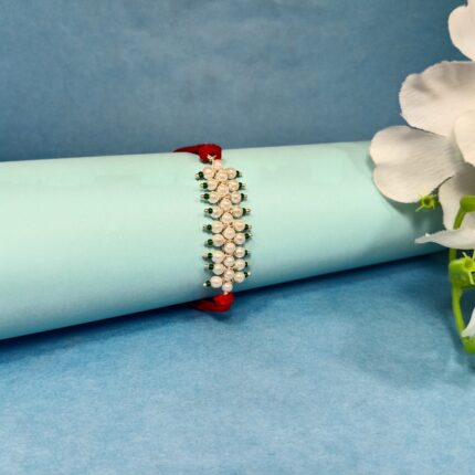 Radiant Pearl Rakhi: Graceful Bonds of Siblings