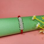Radiant Pearl Rakhi: Graceful Bonds of Siblings