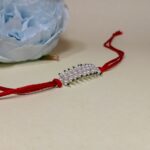 Radiant Pearl Rakhi: Graceful Bonds of Siblings