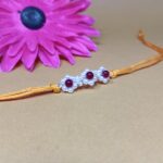 925 Silver Floral Rakhi with Red Beads