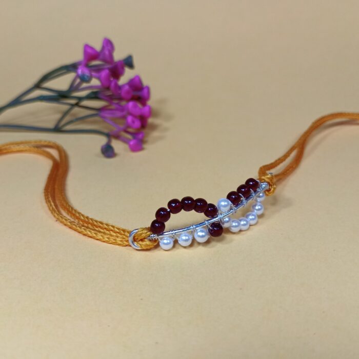 Timeless Maroon Pearl Rakhi: Celebrating Sibling Bond with Elegance