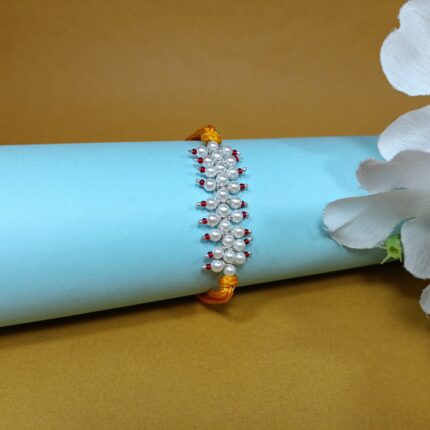 Radiant pink Pearl Rakhi: Graceful Bonds of Siblings