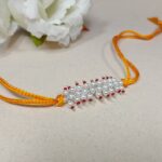 Radiant pink Pearl Rakhi: Graceful Bonds of Siblings