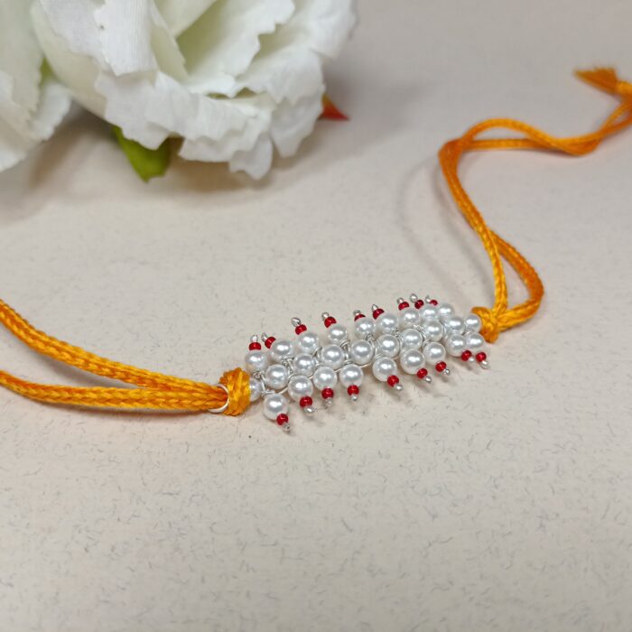 Radiant pink Pearl Rakhi: Graceful Bonds of Siblings