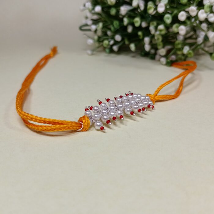 Radiant pink Pearl Rakhi: Graceful Bonds of Siblings