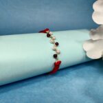 925 Silver Maroon Moti Rakhi: Timeless Pearl Elegance