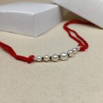 Timeless Pearl & Red Thread Rakhi: A Symbol of Pure Bond