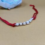 Timeless Pearl & Red Thread Rakhi: A Symbol of Pure Bond