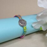 Auspicious Swastika Silver Medallion Rakhi with Multi-Color Thread