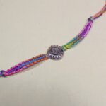 Auspicious Swastika Silver Medallion Rakhi with Multi-Color Thread