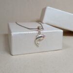 Silver Dolphin Pendant – Graceful Ocean Charm with Red CZ Eye
