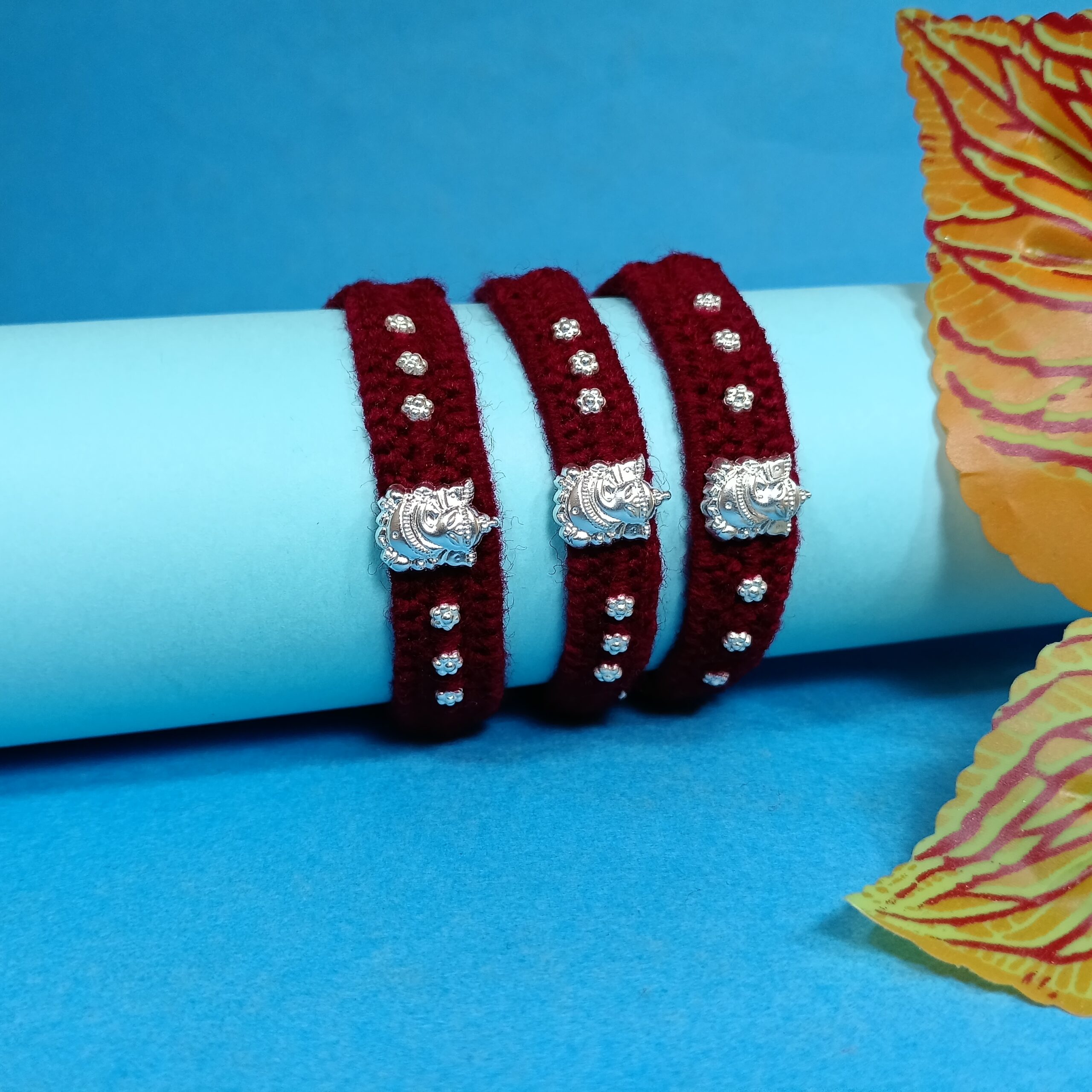 IMG_20250724_185237 Pure Silver Ganesha Rakhi – Sacred Protection Thread in Maroon (3 pieces )