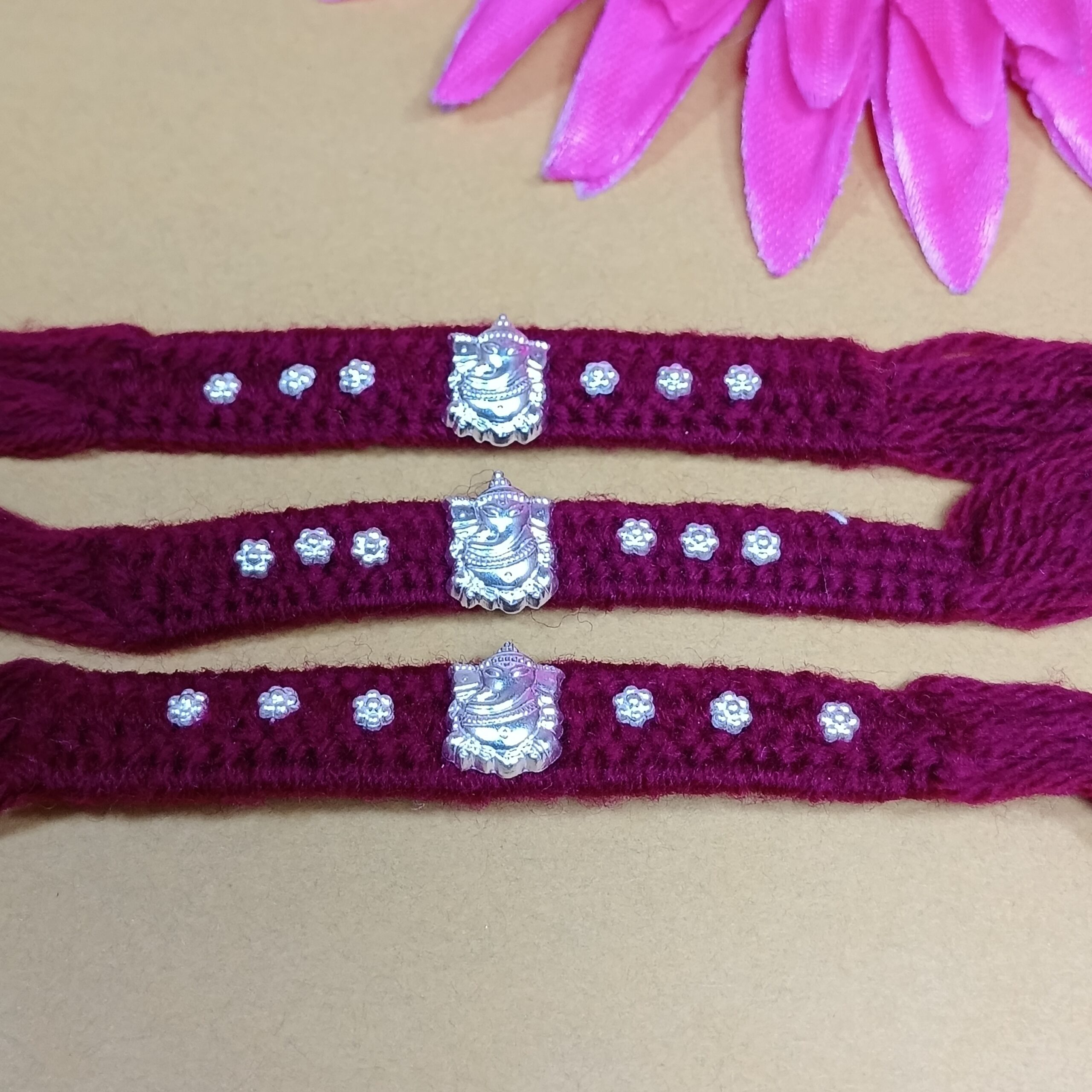 IMG_20250724_185509 Pure Silver Ganesha Rakhi – Sacred Protection Thread in Maroon (3 pieces )