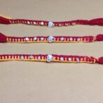 Pure Silver OM Rakhi – Auspicious Red & Yellow Thread with Sparkling CZ Stones