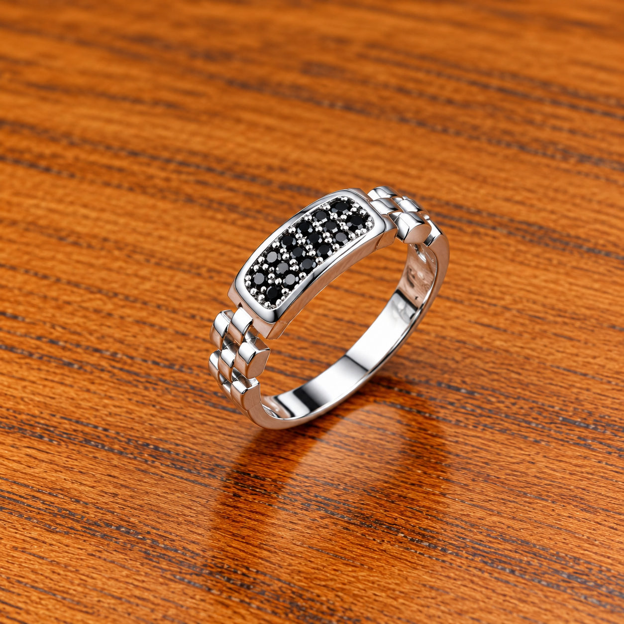 Polished Silver Ring on Warm Wood Elegant Pure Silver Ring with Black Stone